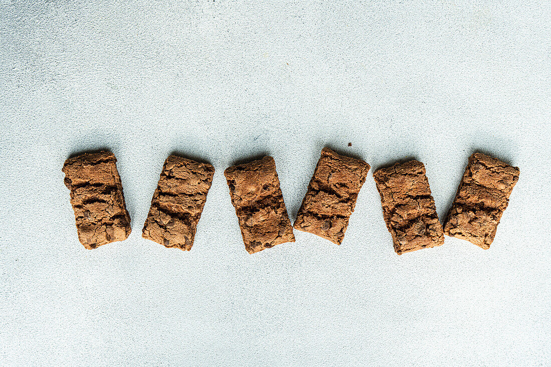 Top view of fresh baked chocolate cookies on concrete background