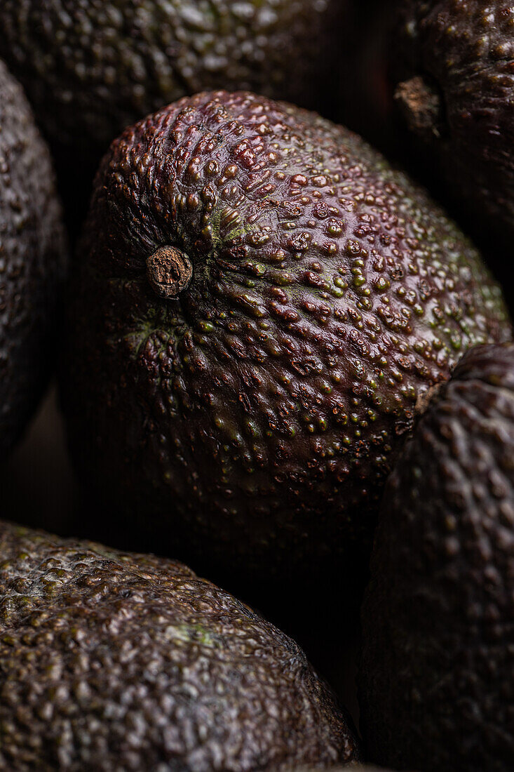 From above full frame of whole ripe brown avocados placed together as background