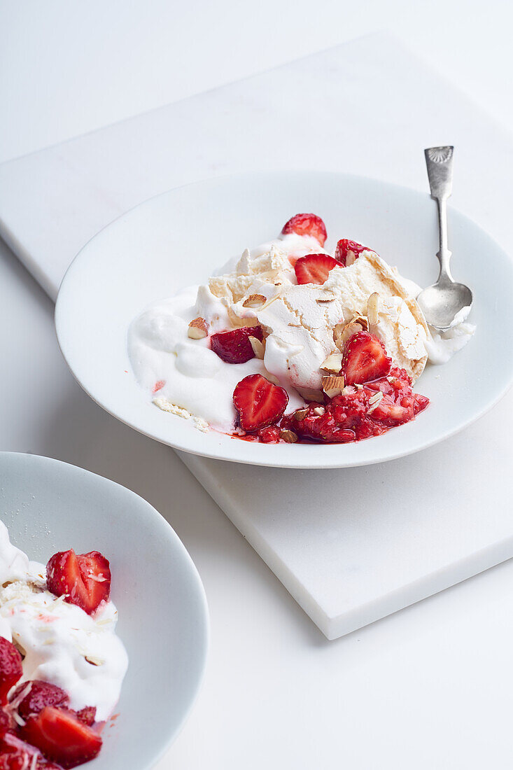 Dessert with berries, meringue and whipped cream. Eton's mess with strawberries, sweet treat with summer mood