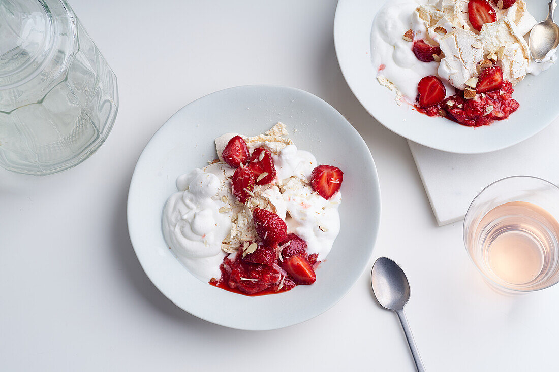 Dessert with strawberries, meringue and whipped cream viewed from above