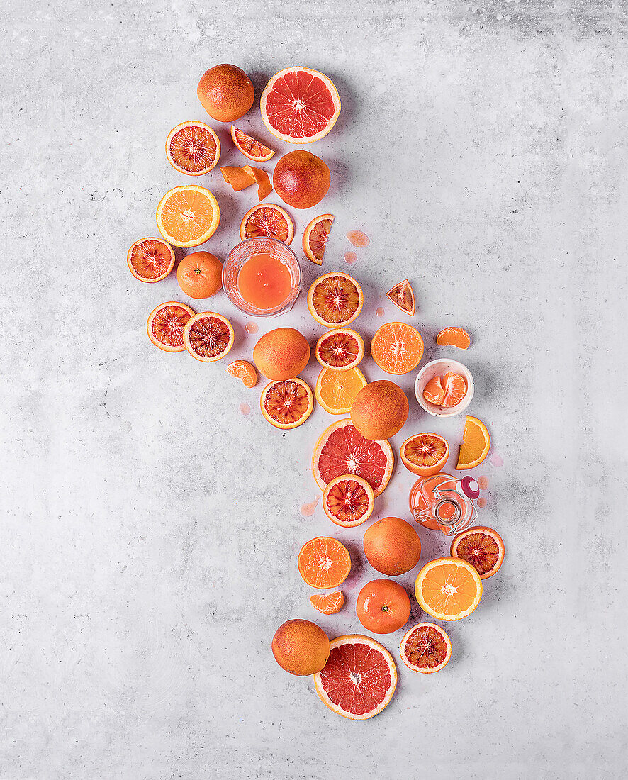 Top view of sanguine fruit on white table cut into half parts