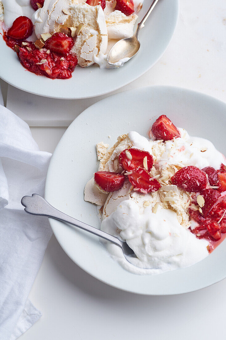 Dessert with berries, meringue and whipped cream. Closeup image of Eton's mess with strawberries, sweet treat with summer mood