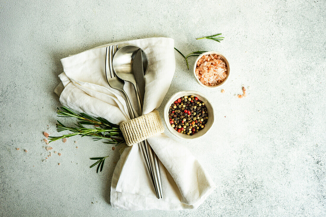 From above cooking concept with spices and rosemary herb on concrete background