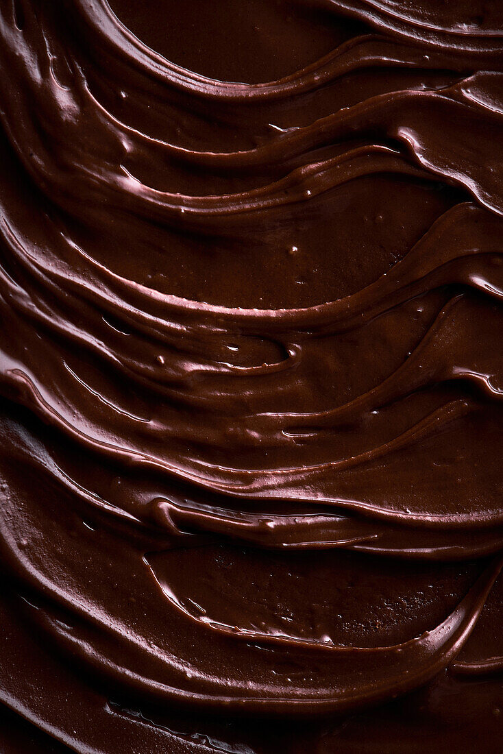 From above background with tempting brown chocolate-flavored paste for spreading on bread