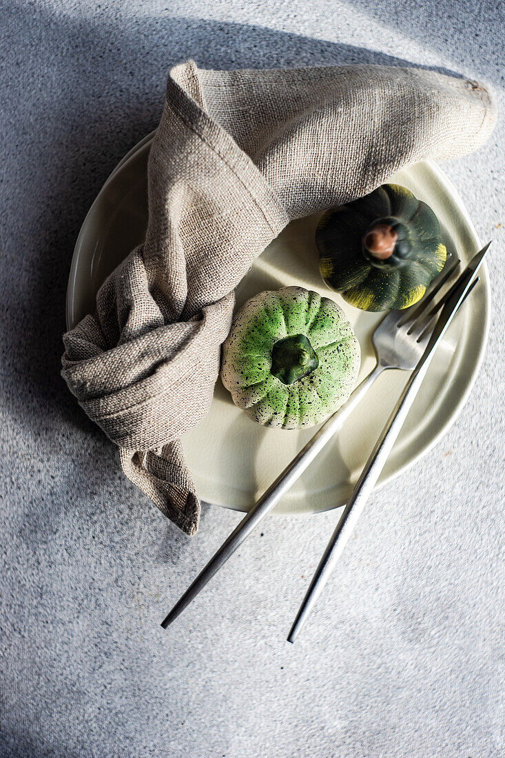 Festive place setting for autumnal dinner with holiday seasonal decoration