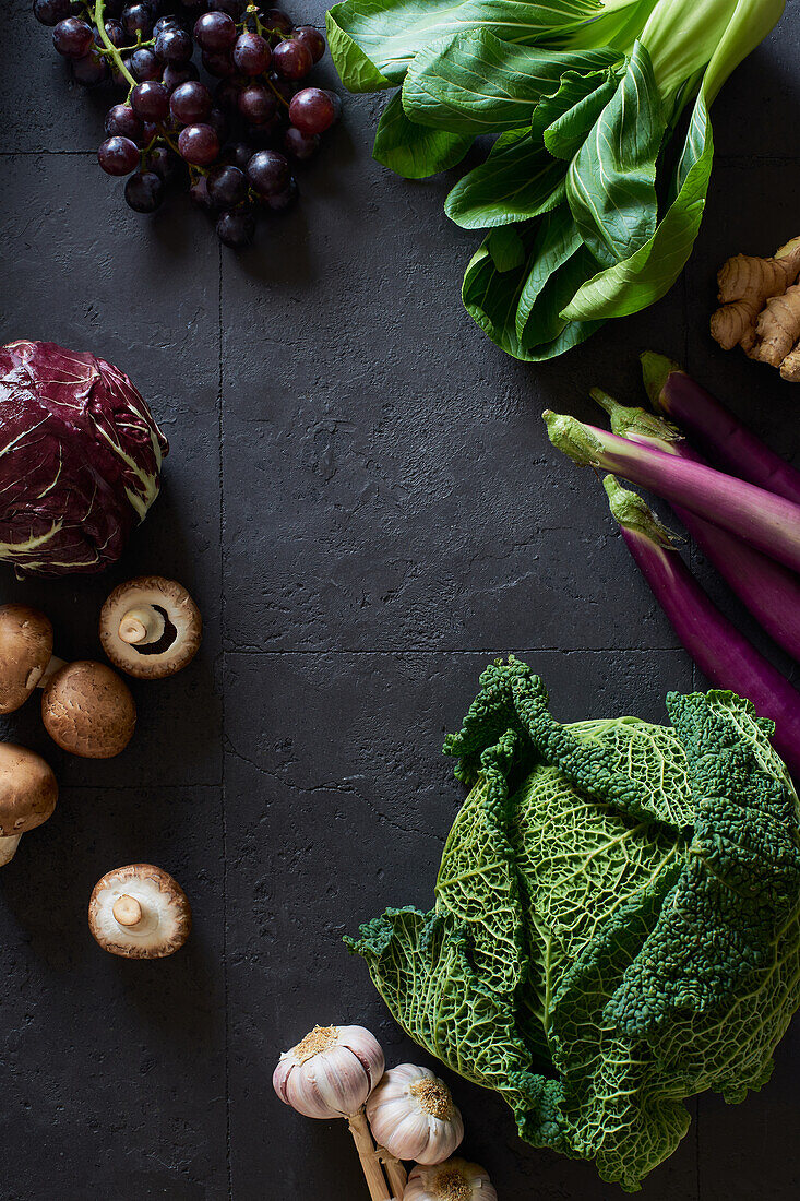 From above still life with fresh fruits and vegetables on dark background