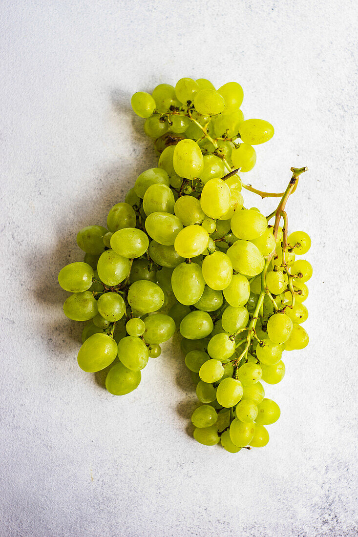 From above ripe green grape on concrete background