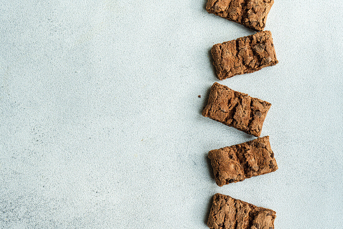 Top view of fresh baked chocolate cookies on concrete background