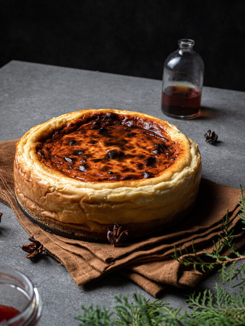 Leckerer hausgemachter süßer Käsekuchen in einem Glas mit Marmelade auf einem grauen Tisch