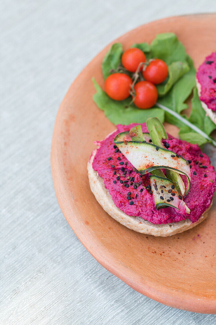 Fresh vegetable salad made of purple cabbage carrot and herbs served in bowl on plate with vegetarian sandwiches for lunch