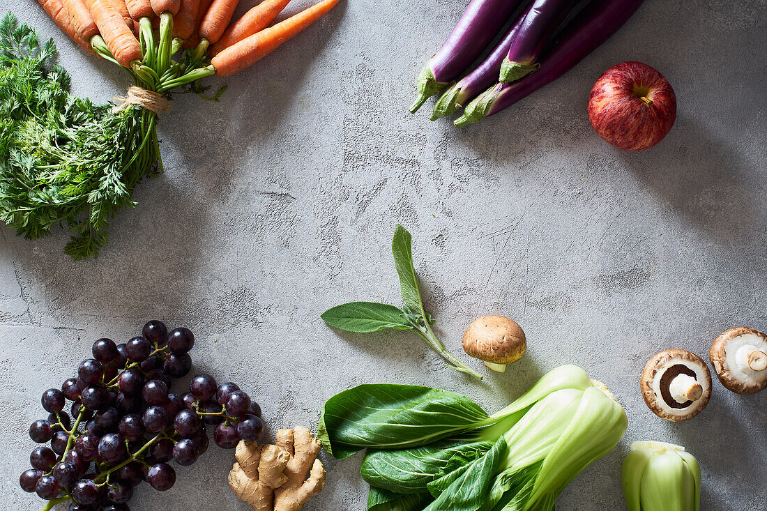 Food concept, flat lay with fresh fruits and vegetables on gray background with copy space