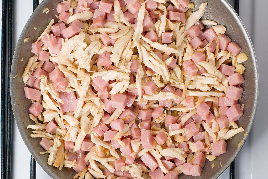 Top view of chopped ingredients consisting of chopped meat and chicken for cooking dish on stove