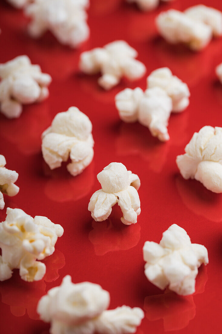 Closeup of some popcorn on a red background