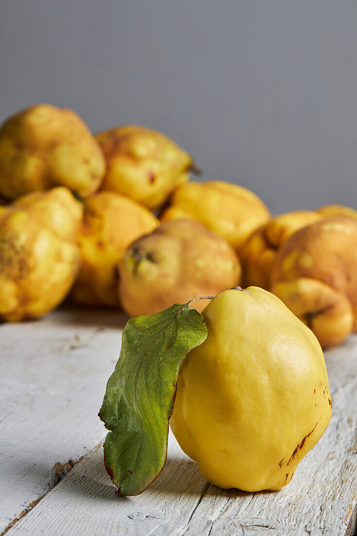 Fresh whole sour yellow lemons on white wooden background