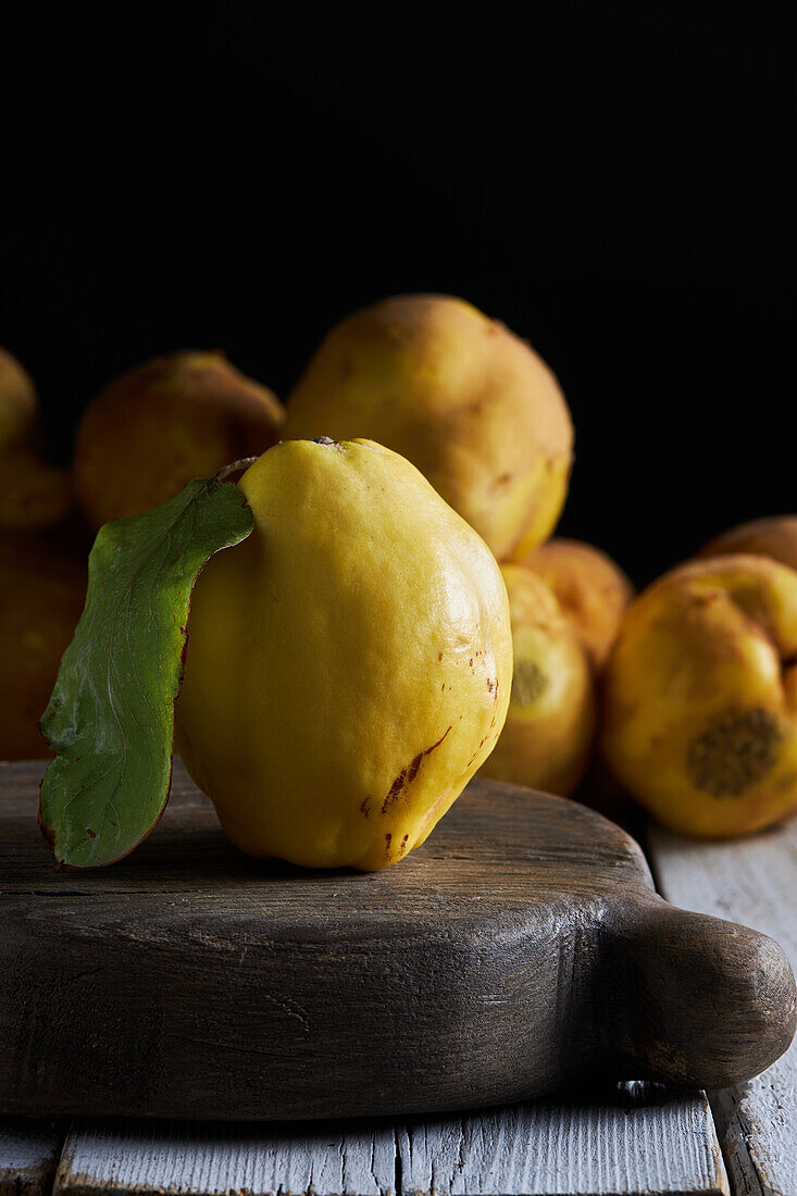 Fresh whole sour yellow lemon on white wooden background