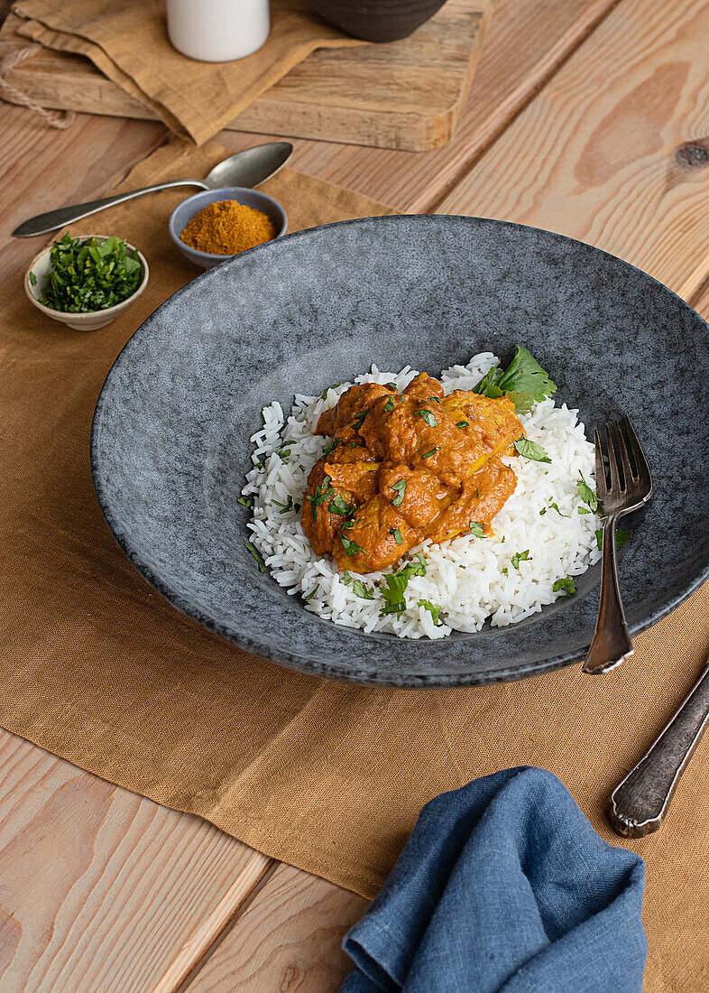 From above chicken garam tikka masala served on plate on wooden table background