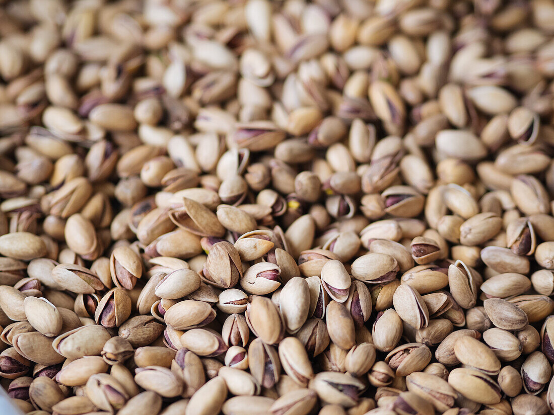 Full frame closeup of pile with dried pistachios in heap placed on stall at market