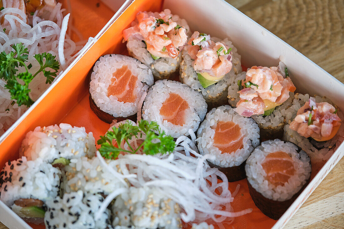 Stock photo of box full of different types of sushi in japanese restaurant.