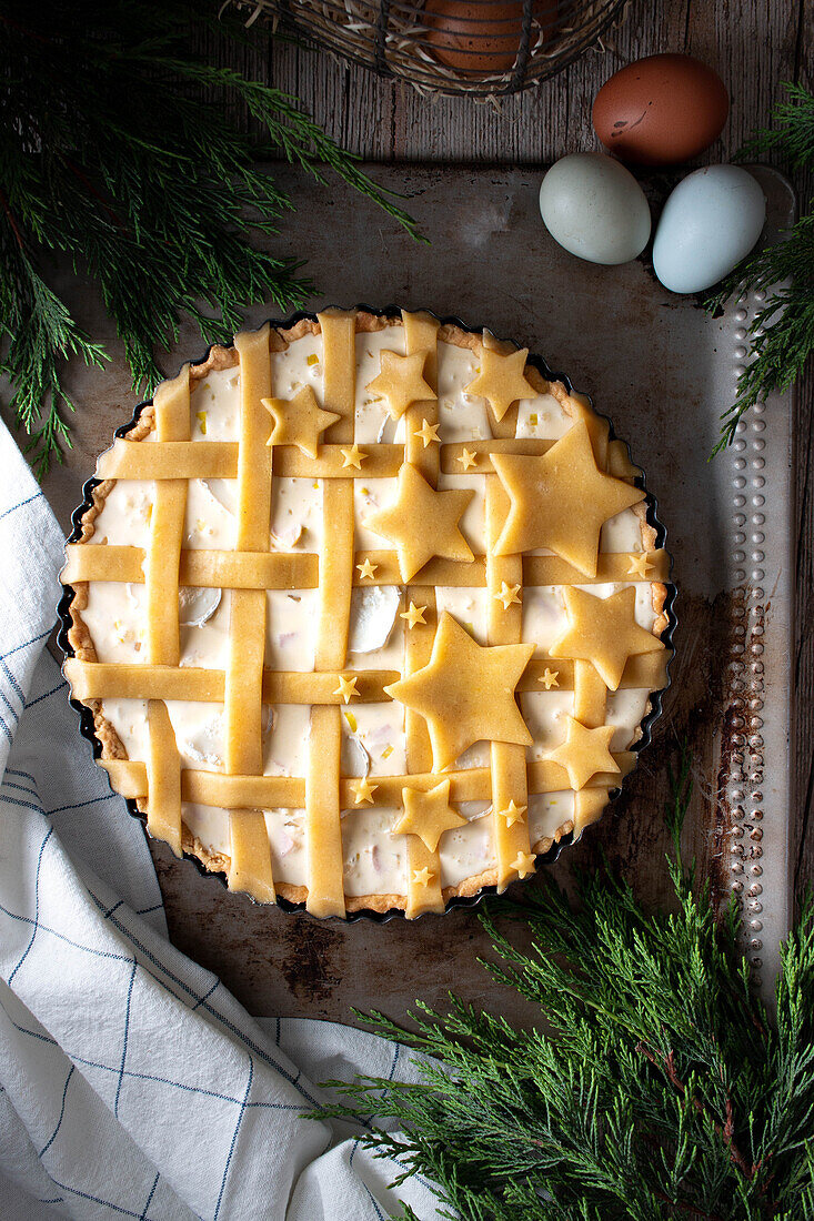 From above delicious stars quiche pie ready to bake with eggs decorated stars from dough in baking dish