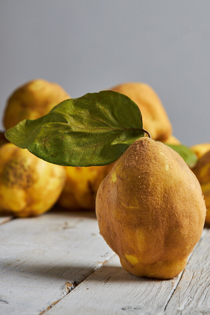 Fresh whole sour yellow lemons on white wooden background