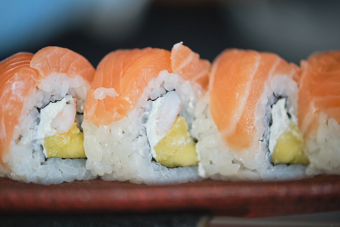 Stock photo of delicious sushi bites with salmon and seeds in japanese restaurant.