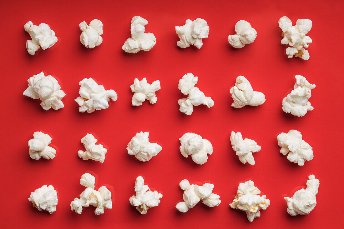 Closeup of some popcorn on a red background