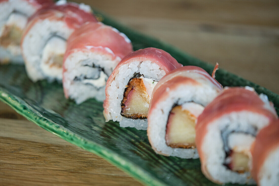 Stock photo of delicious sushi bites with salmon and seeds in japanese restaurant.