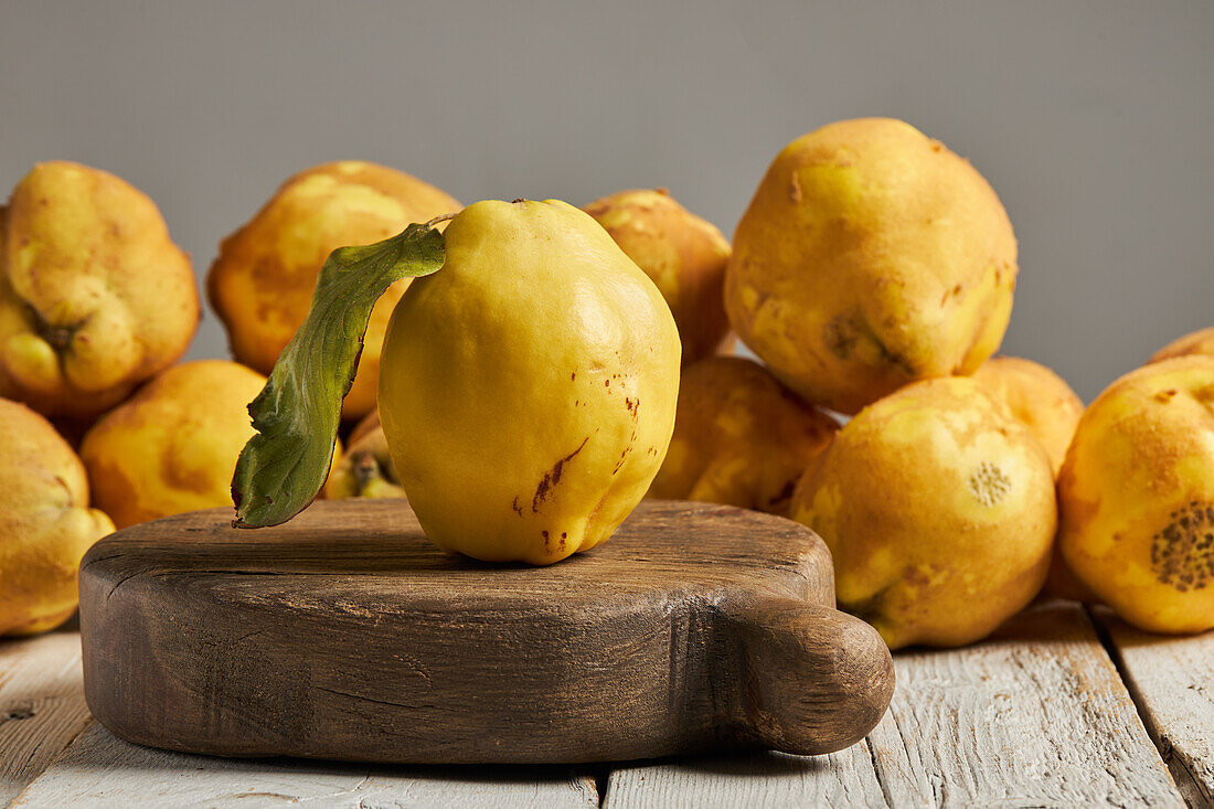 Fresh whole sour yellow lemon on white wooden background