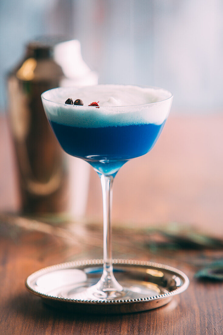 Blue cocktail on a wooden table