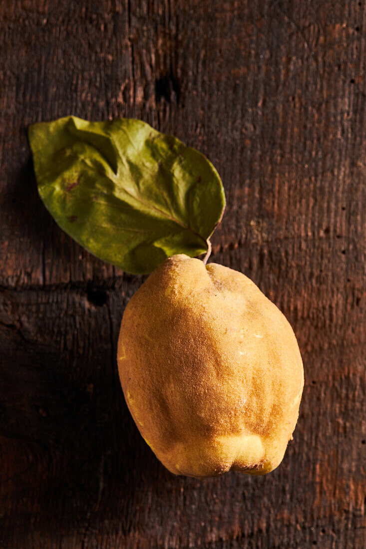 Top view of fresh whole sour yellow lemon on wooden background