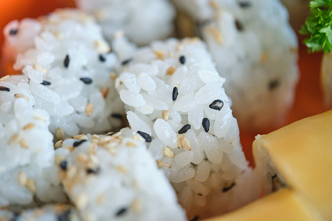 Stock photo of delicious box of sushi with natural seeds.
