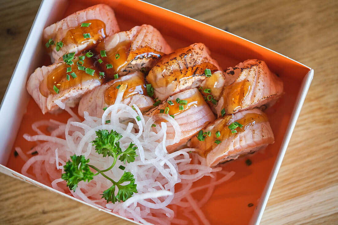 Stock photo of delicious box of sushi with special sauces.