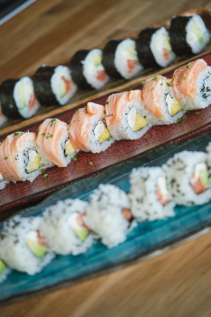 Stock photo of yummy and varied sushi plates in japanese restaurant.
