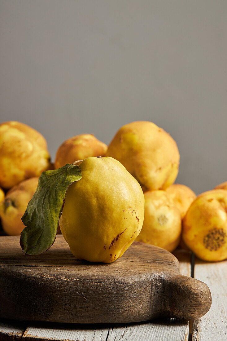 Fresh whole sour yellow lemon on white wooden background