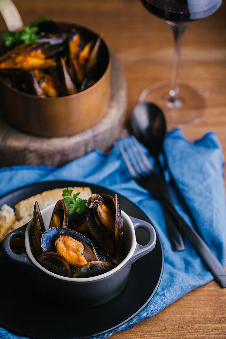 Delectable mussels with herbs in metal saucepan