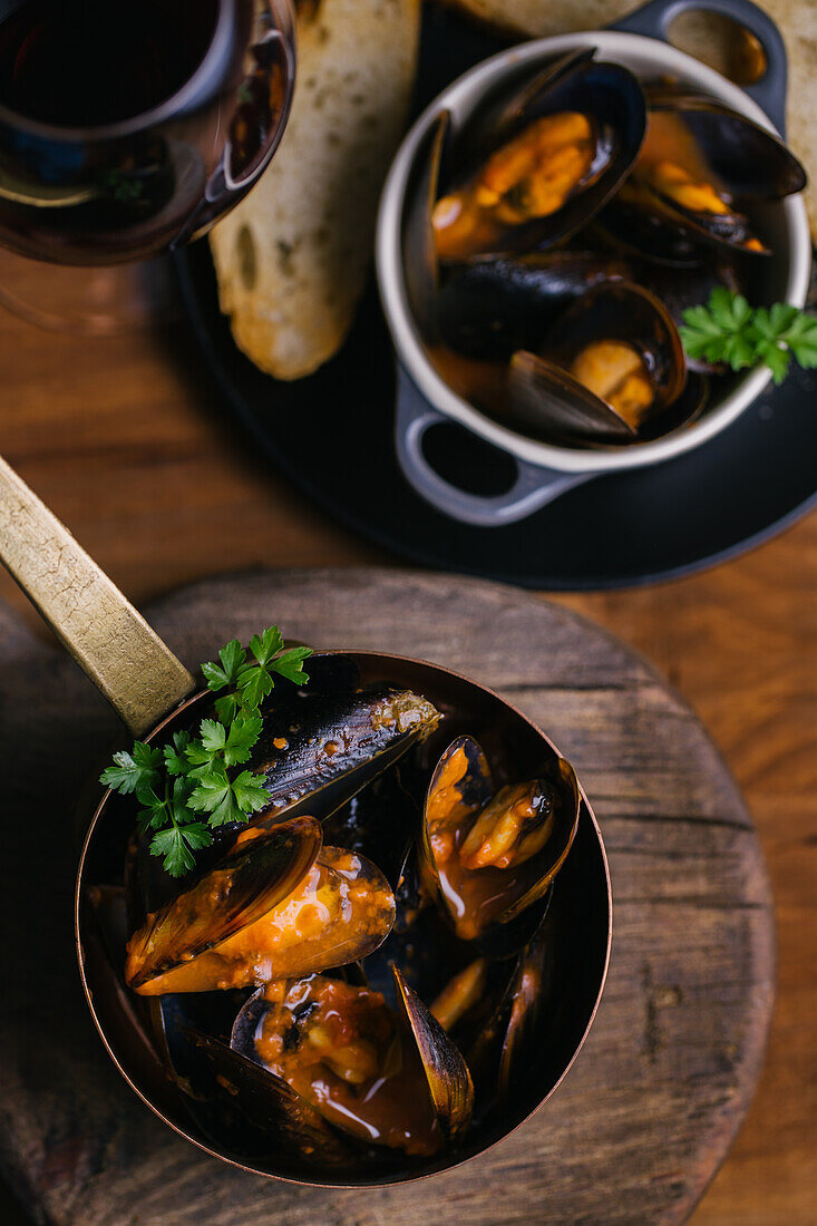 Delectable mussels with herbs in metal saucepan