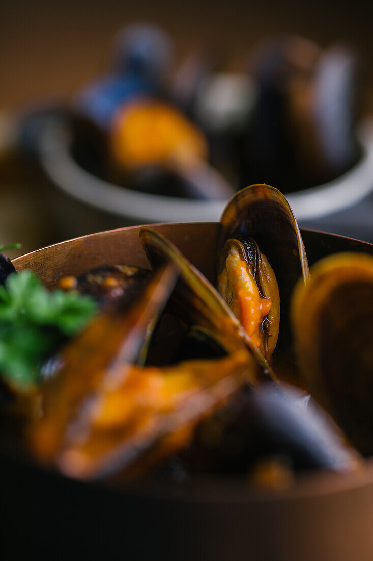 Delectable mussels with herbs in metal saucepan