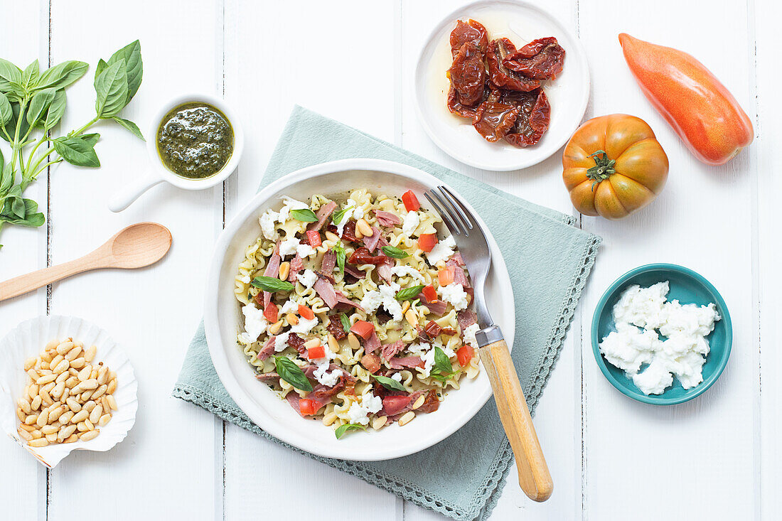 From above appetizing salad mixed with various fresh ingredients on wooden white table