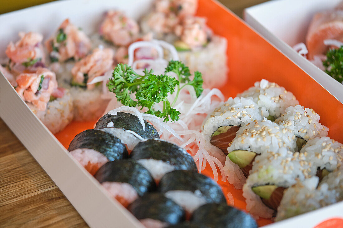 Stock photo of box full of different types of sushi in japanese restaurant.