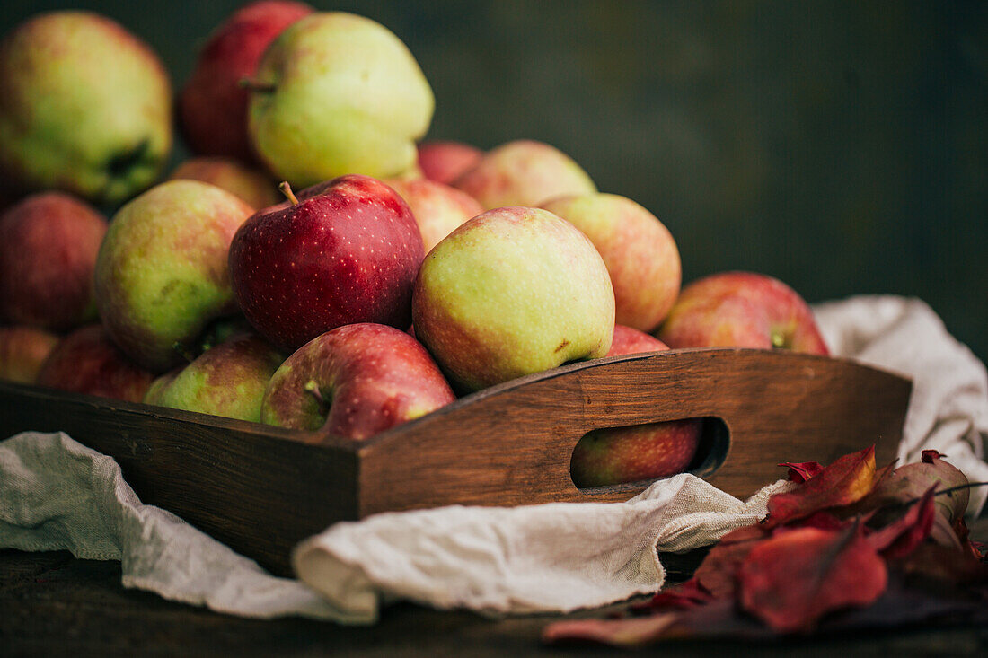 Fresh red apples in a box on table