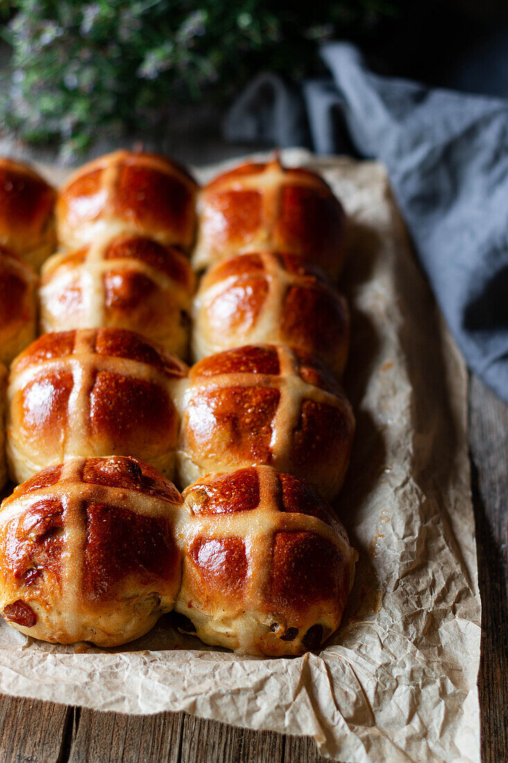 crop freshly baked hot cross buns on baking tray