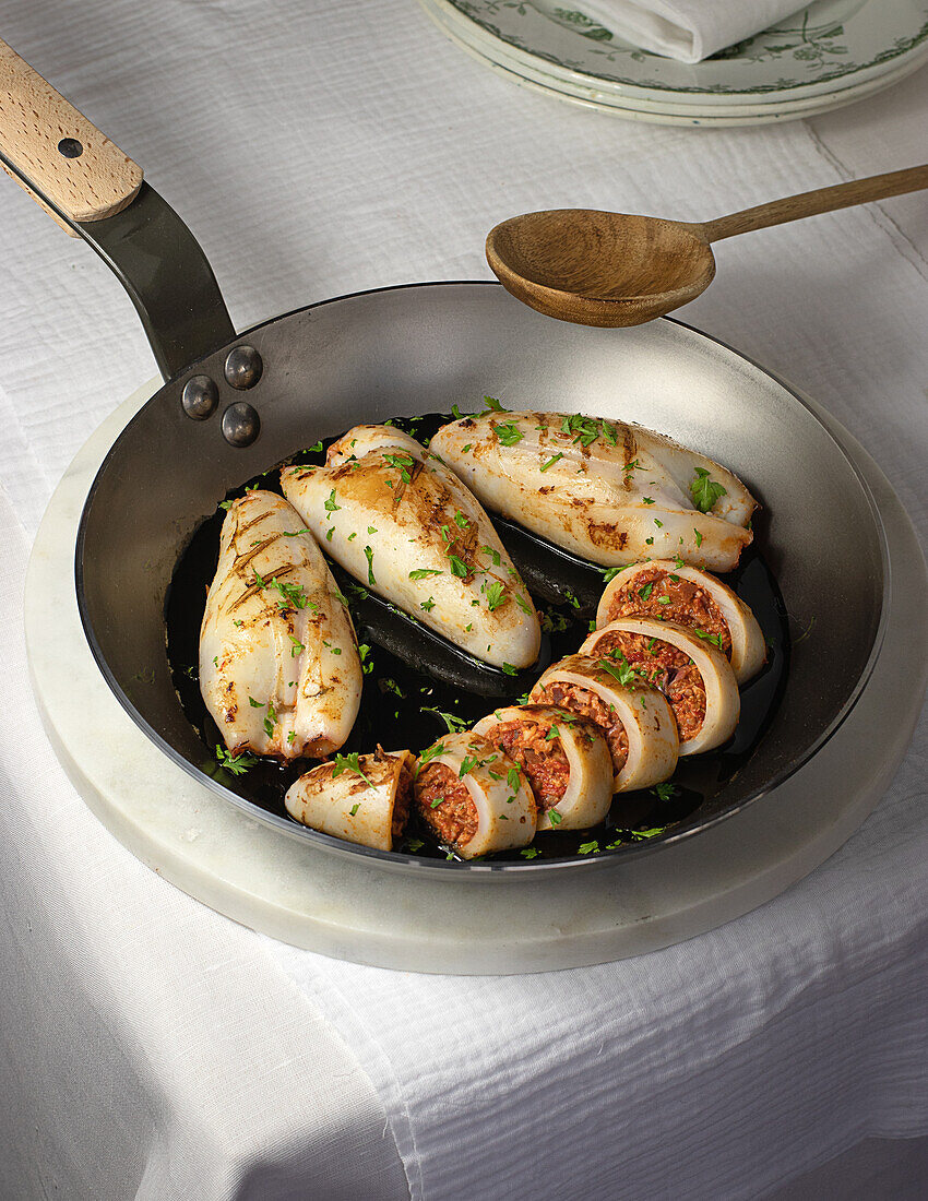 From above fresh tasty stuffed squid served on pan on dinning table