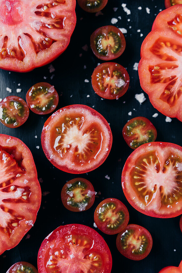 From above half cut tomatoes on table