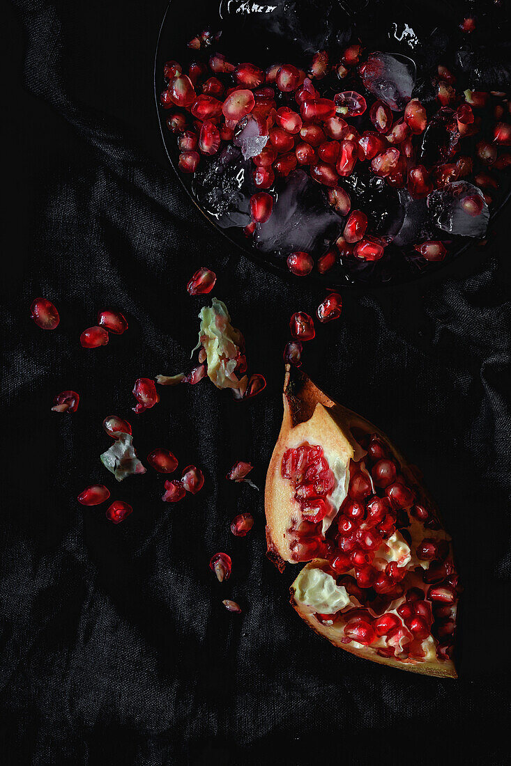Fresh and red pomegranate on dark background. Fall season fruit. Top flay; top view