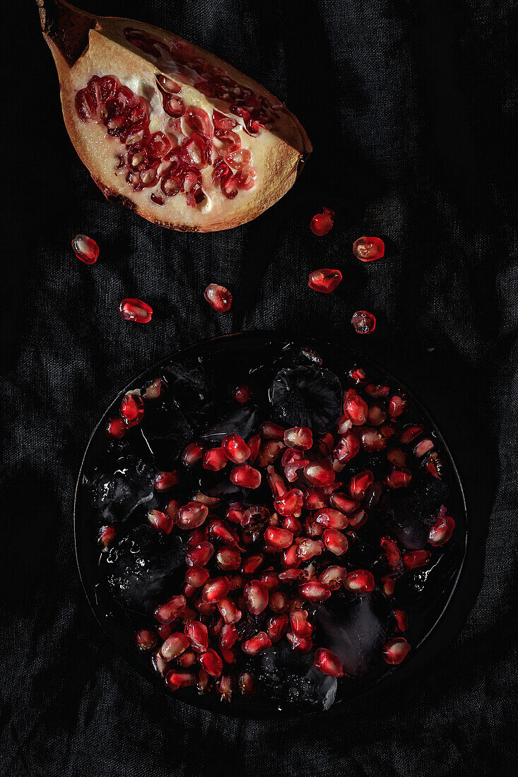 Fresh and red pomegranate on dark background. Fall season fruit. Top flay; top view