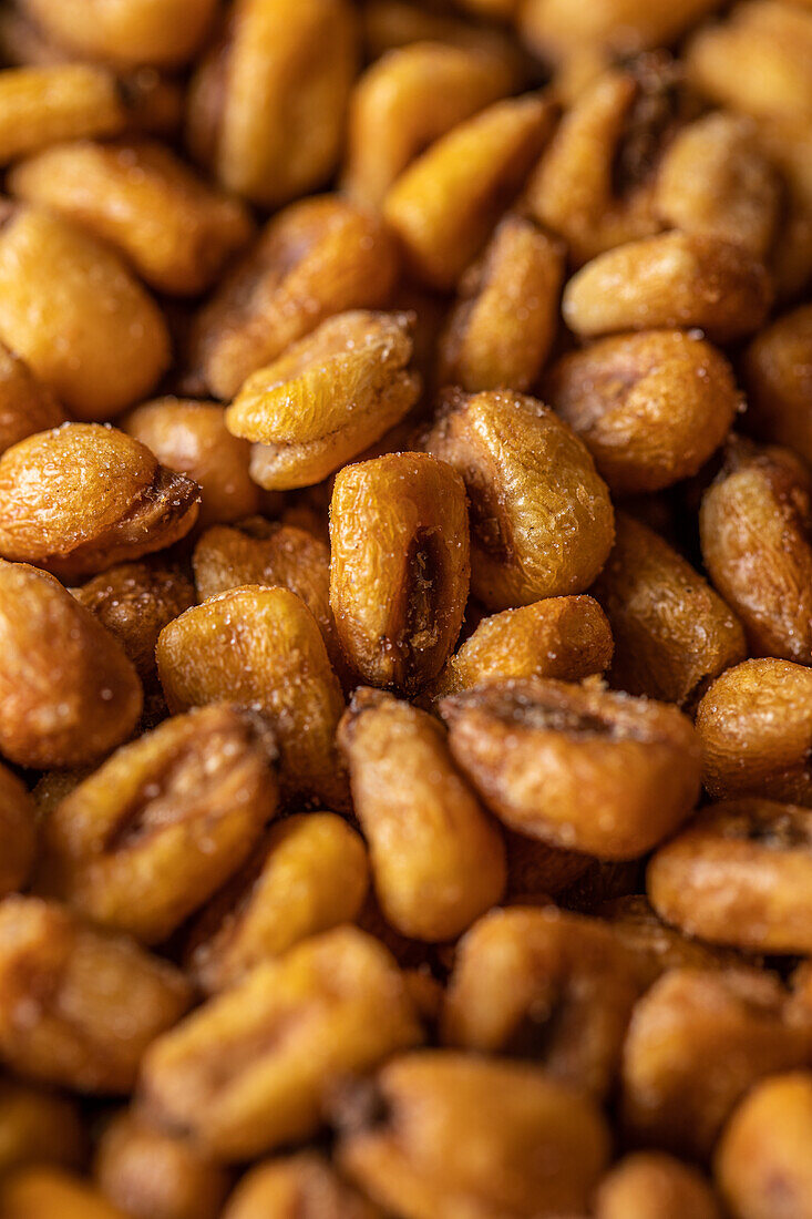 Full frame top view of heap of crispy roasted corn kernels scattered on surface