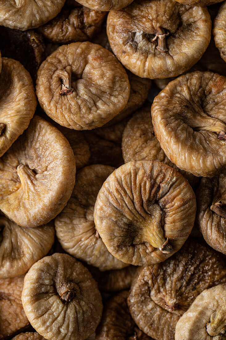 Full frame high angle of shrunken dehydrated Turkish figs stacked in pile on counter