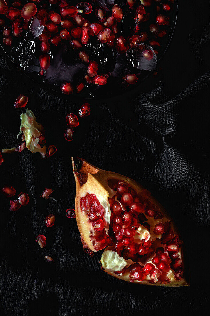 Fresh and red pomegranate on dark background. Fall season fruit. Top flay; top view