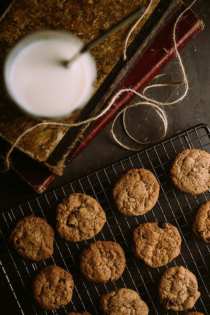 From above homemade chocolate chips cookies on cooling rack with a glass of milk