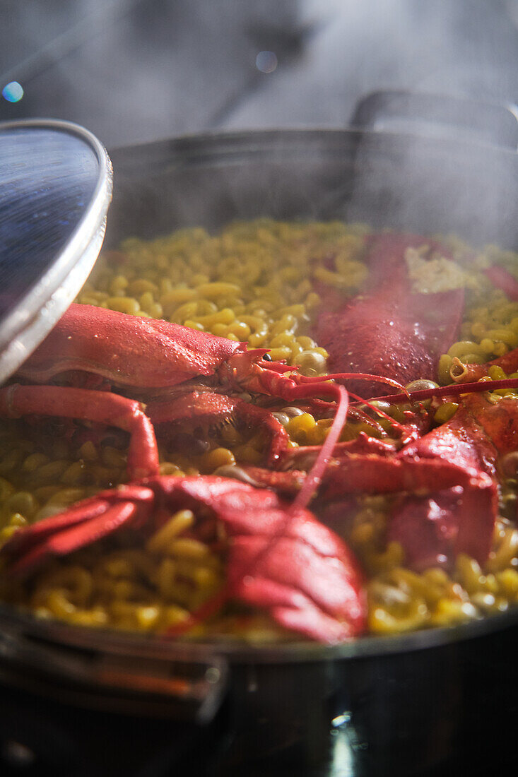 Typical Spanish fideuá with red prawns in cooking pot